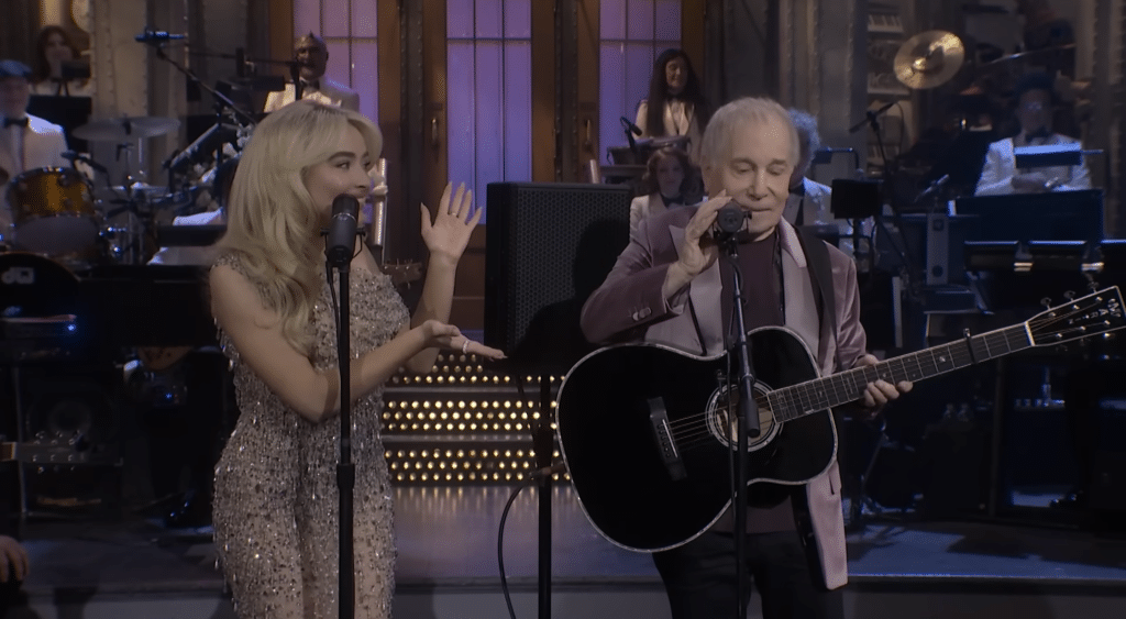Sabrina Carpenter introducing Paul Simon to prepare the crowd for their cover